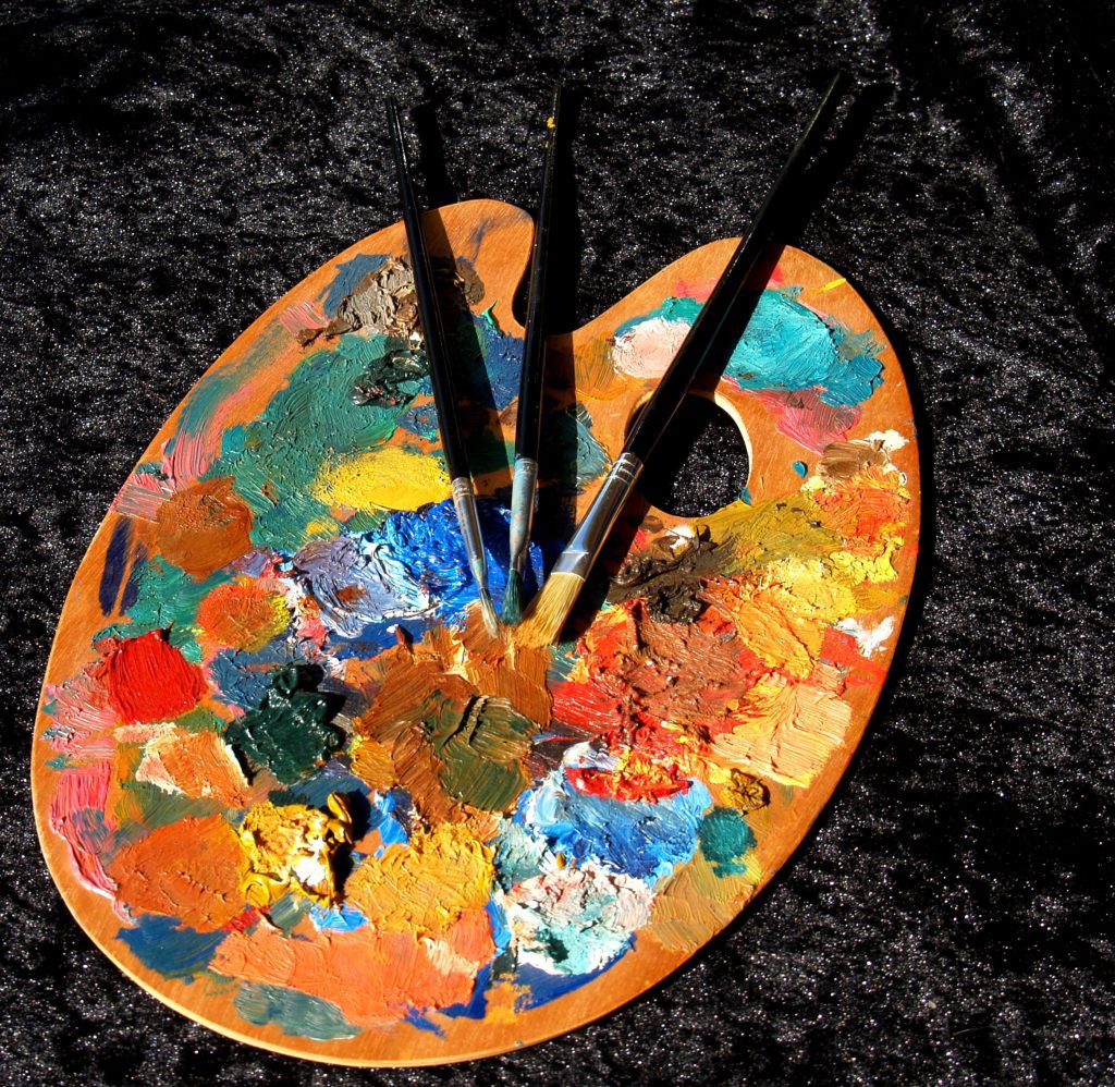 A paint board with three brushes.