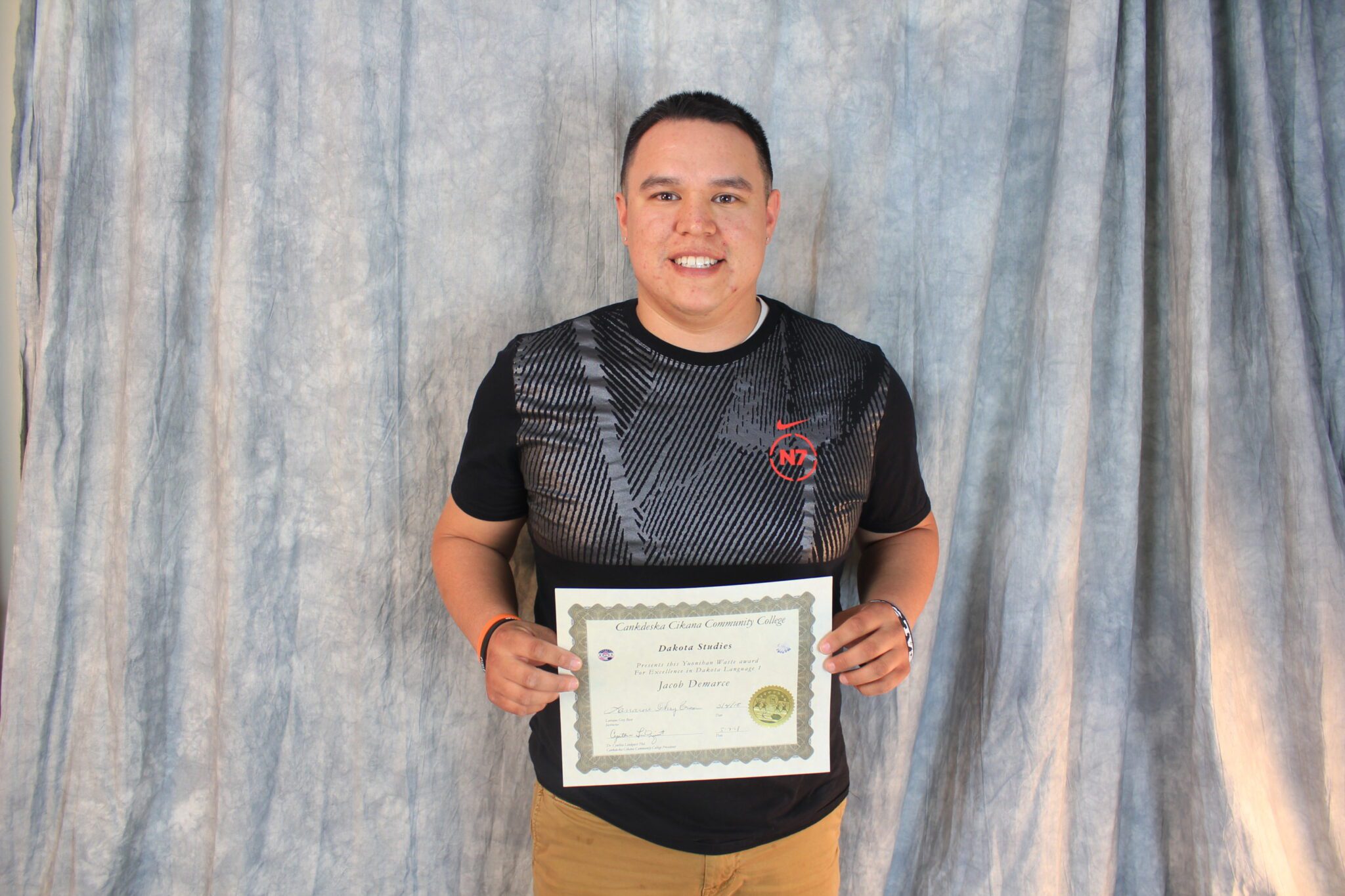 A studen holding his diploma.