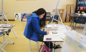 A woman sketching a drawing.