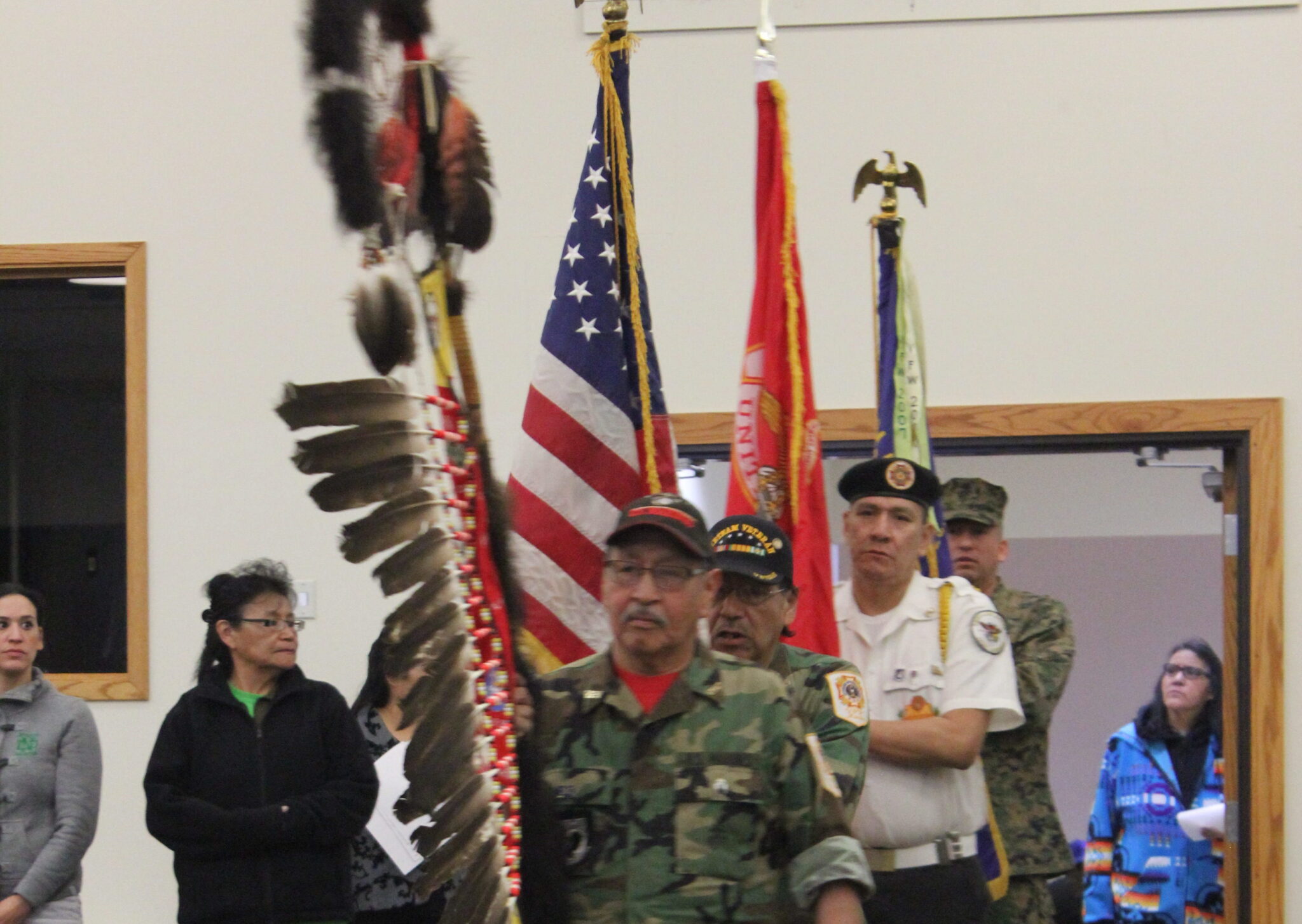 An armed forces color guard making an entrance.