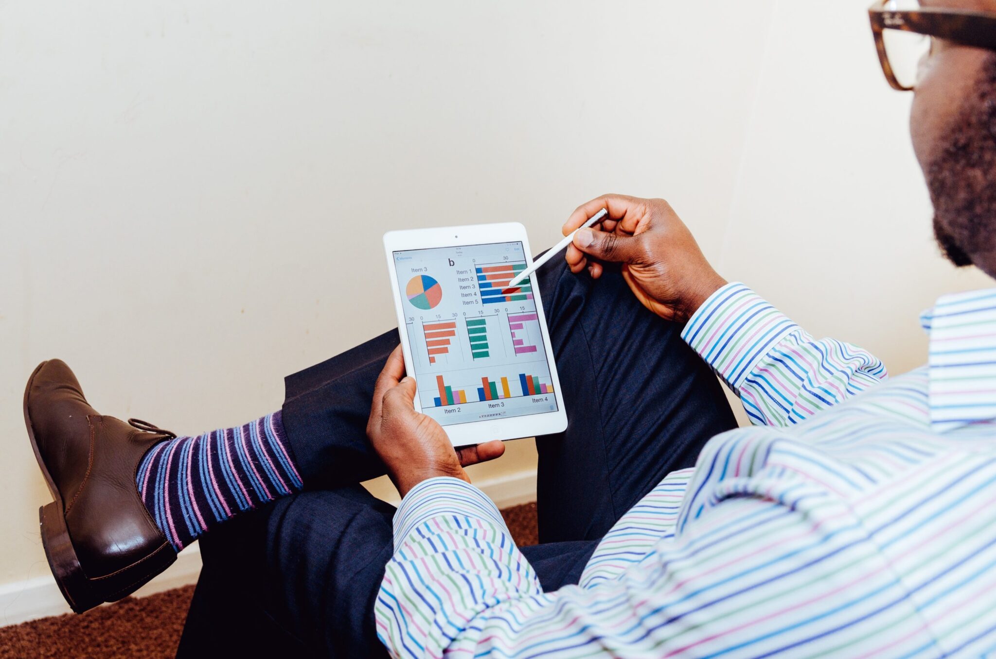 A man reading charts on a tablet device.