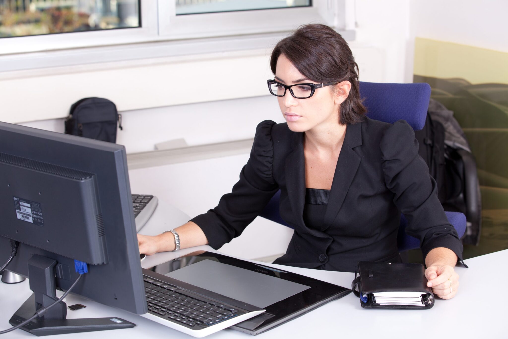 A woman sitting at her desk working.