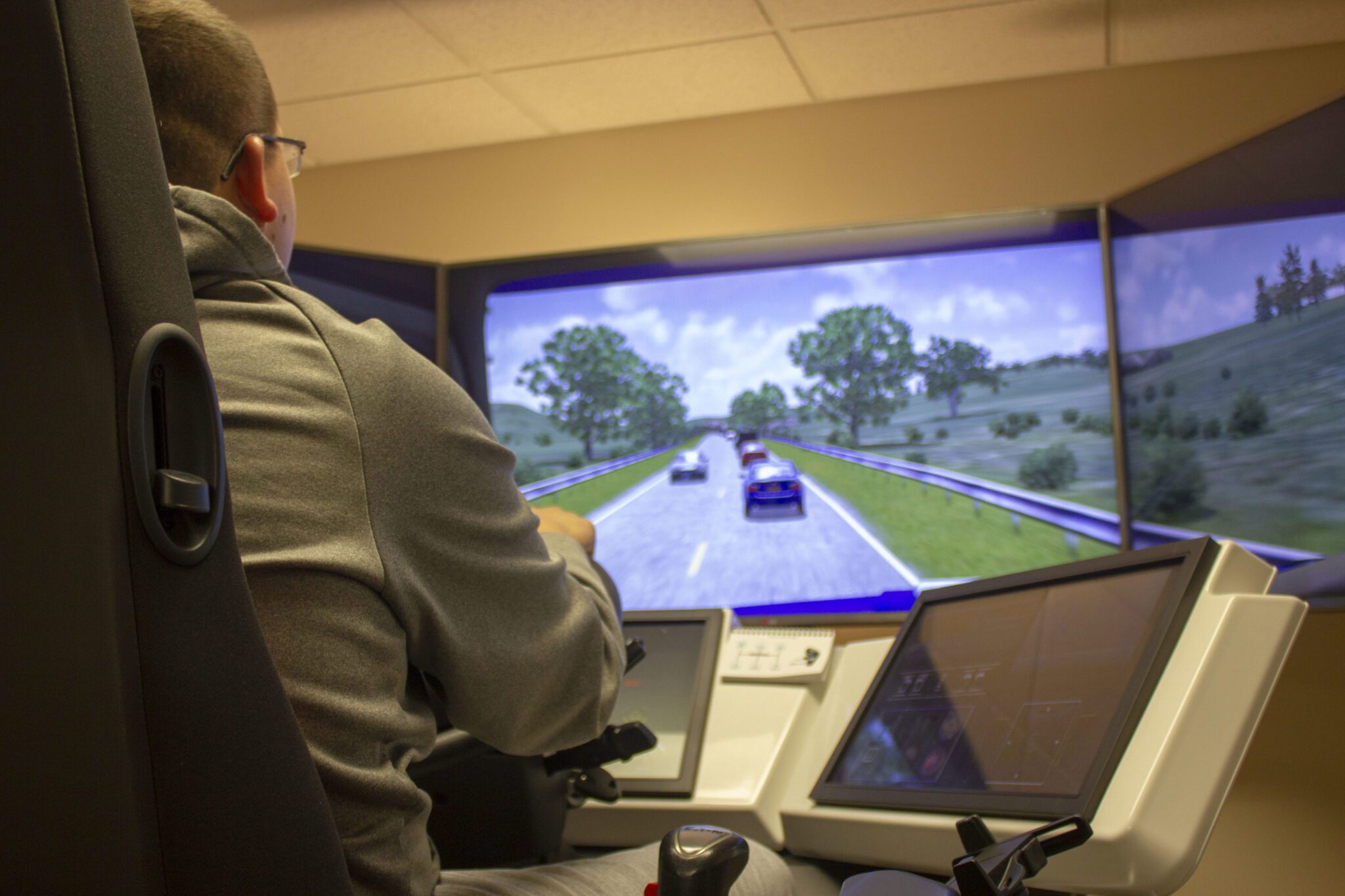 A man testing his truck driving skills on a simulator.